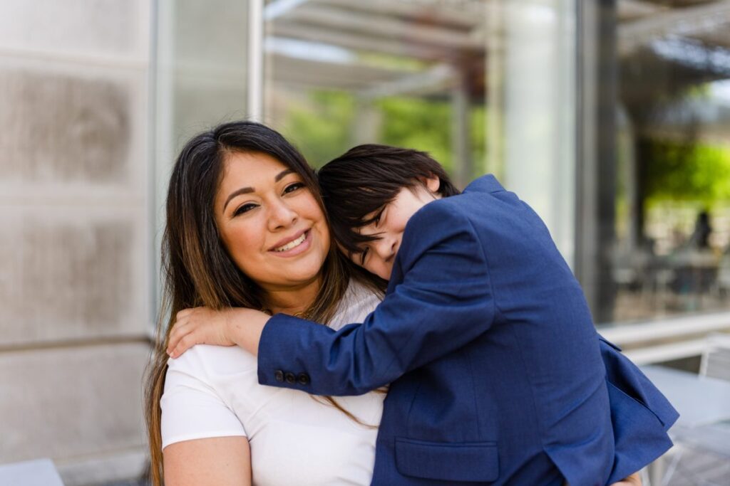 Nellie and her son Bean sharing a hug, representing family support and opportunity through MaaPaa.